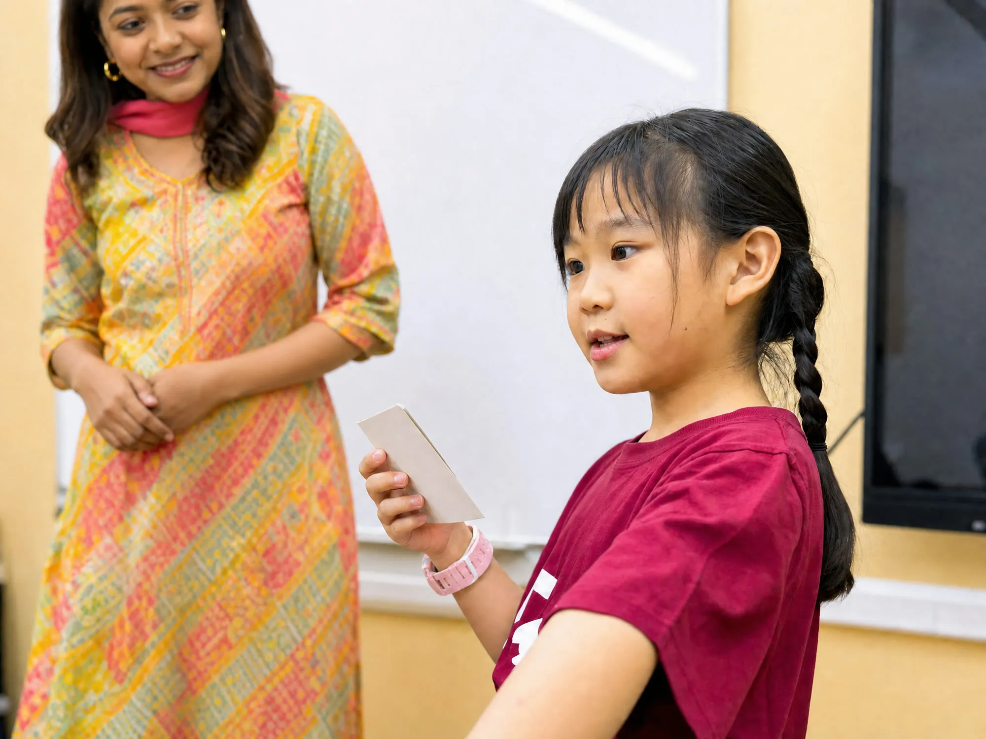 A TITAN student speaking to the class while her educator listens